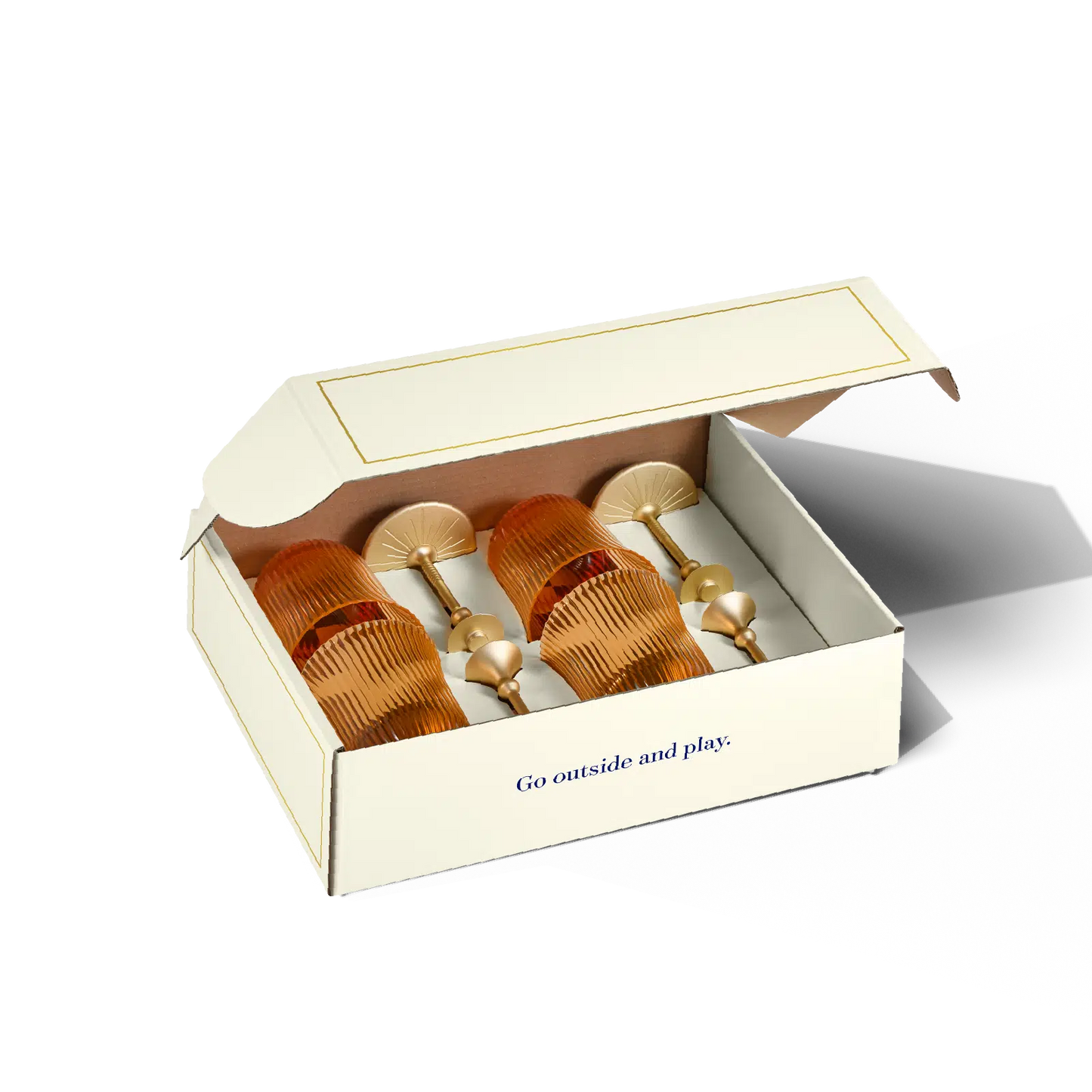 Set of gold hair accessories in a box with 'Go outside and play' text on a white background